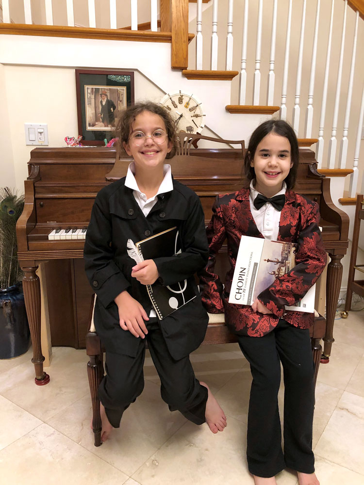 Two girls dressed as composers.